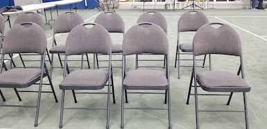 9 High Back Folding Chairs showing with tables in background 
